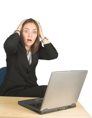 shocked business woman whilst working on her pc.jpeg