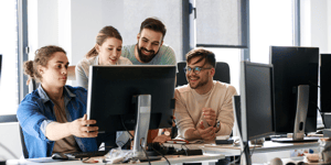 People smiling looking at computer 