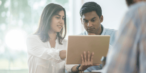 People pointing at computer