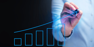 Person writing increasing graph